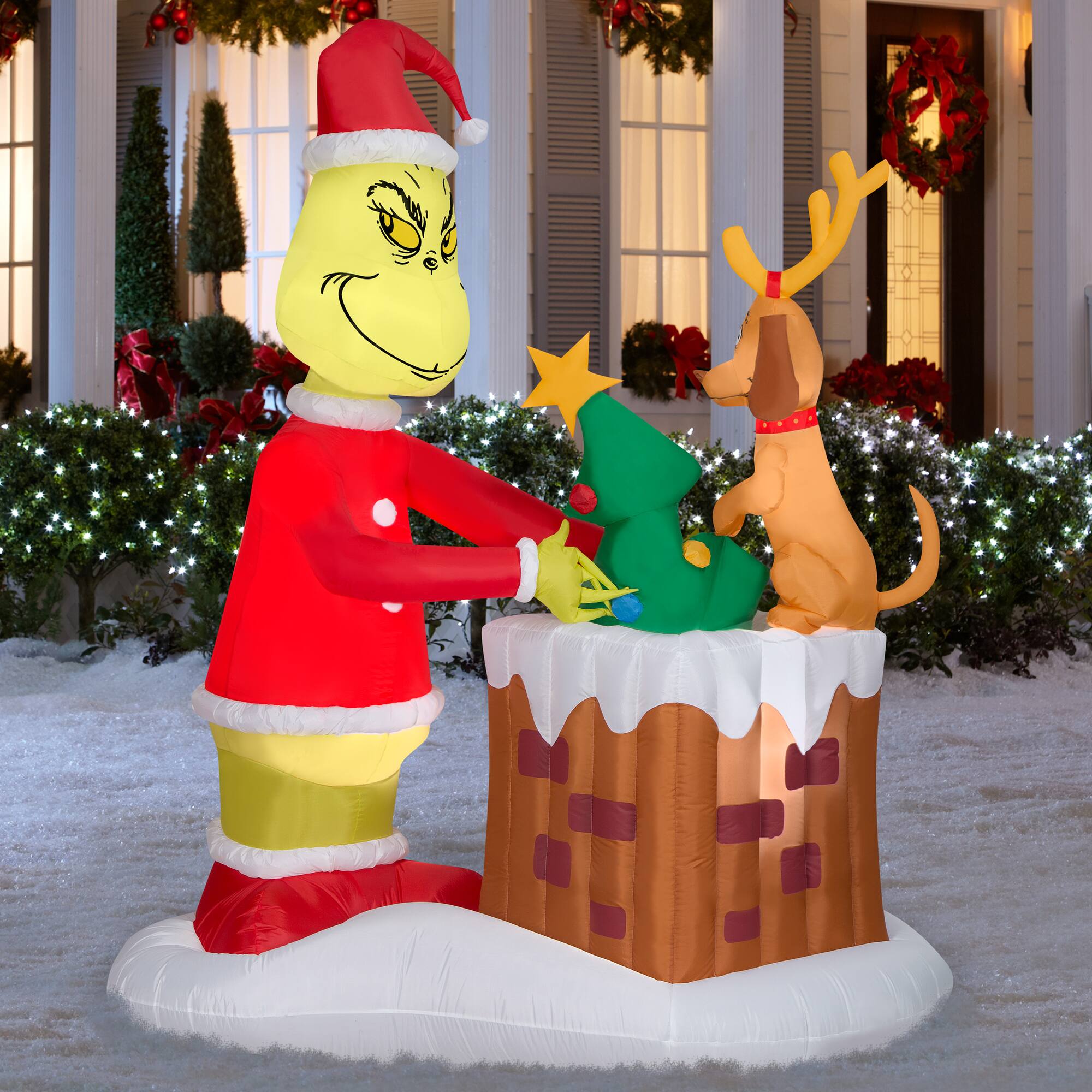 6.5ft. Animated Airblown® Inflatable Christmas Grinch Pulling Tree from Chimney